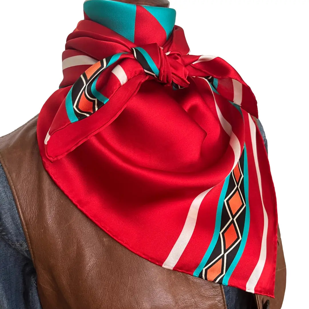 Red bandana silk scarf with large print of cream, red, turquoise and adobe and orange.