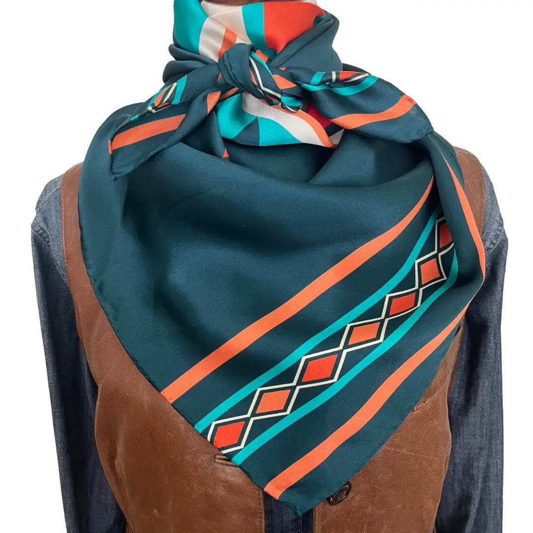 Blue bandana silk scarf with large print of cream, red, turquoise and adobe orange.