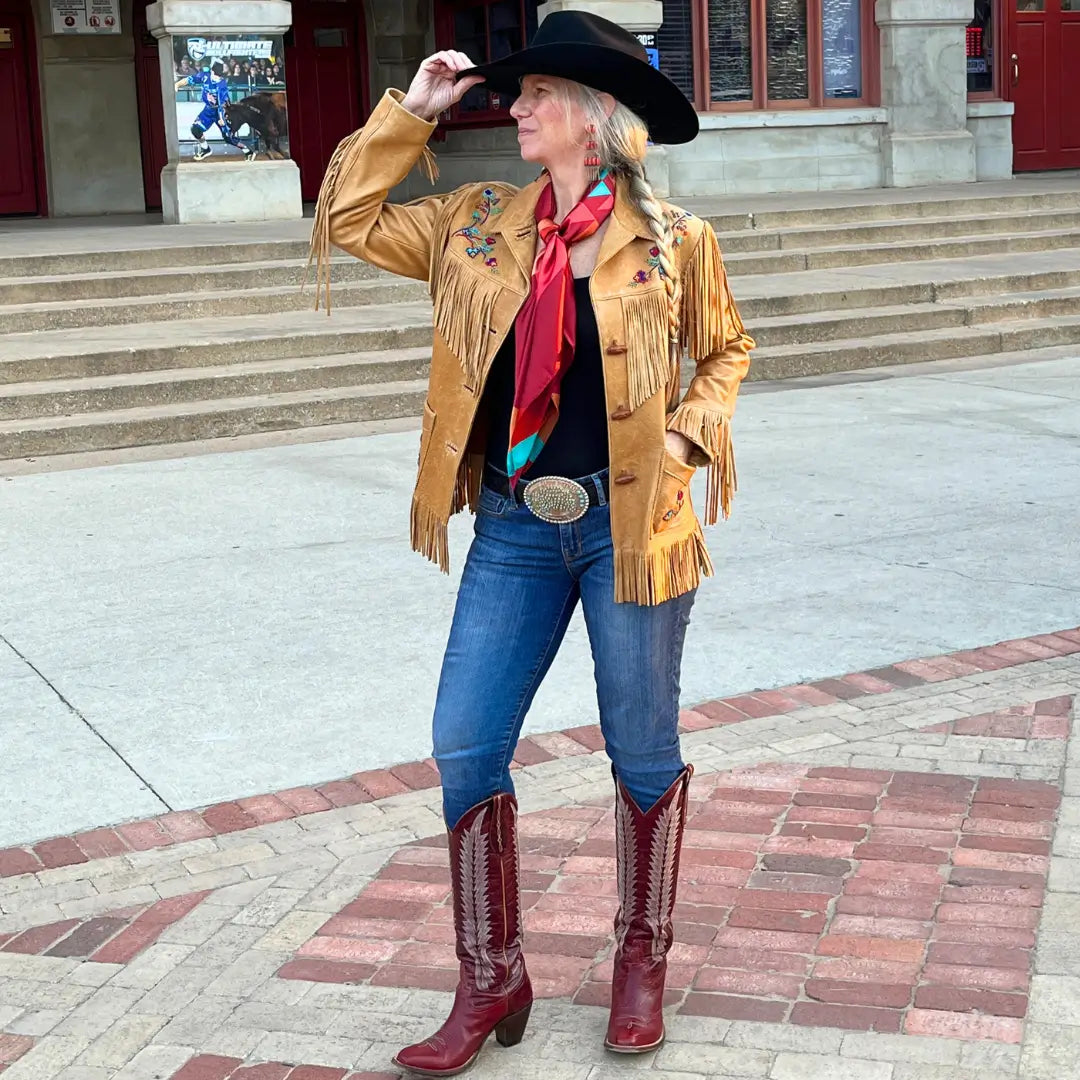 Cowgirl wearing a maroon wild rag silk scarf with copper and turquoise in the Fort Worth Stockyards. 