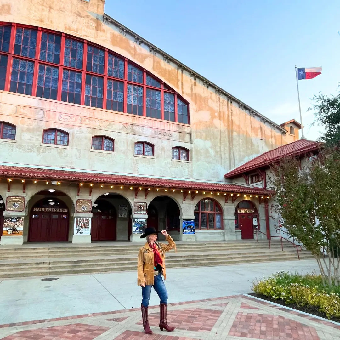 Cowgirl wearing a maroon wild rag silk scarf with copper and turquoise in the Fort Worth Stockyards. 