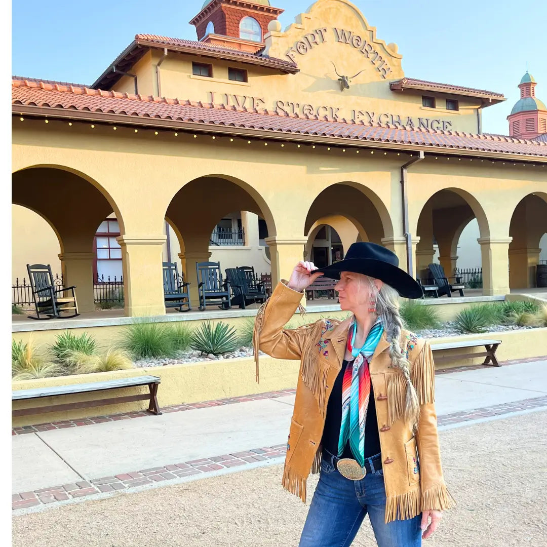 Cowgirl wearing a Cowtown Wild Rags turquoise serape silk scarf with blue, tan, maroon, orange, and coral.