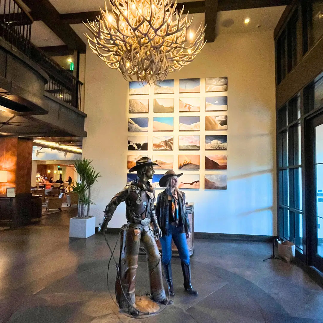 Cowgirl is wearing a southwestern teal blue and copper silk scarf wild rag in the Fort Worth Stockyards.