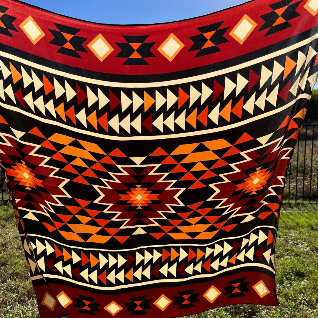 Large Aztec print design with mahogany, copper, burnt orange, cream and black.