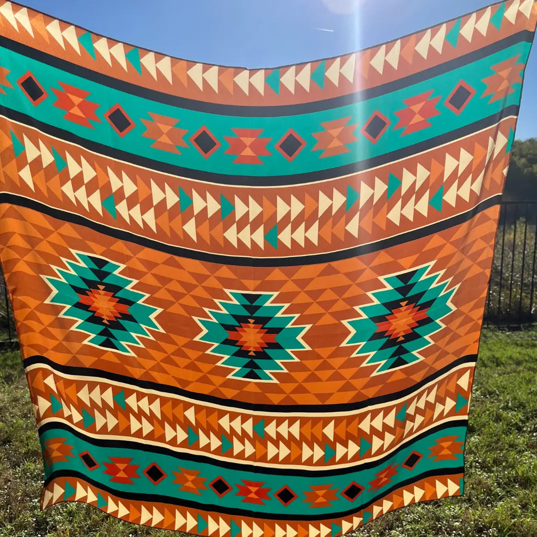 Large Aztec print design with turquoise, copper, burnt orange, cream and black.