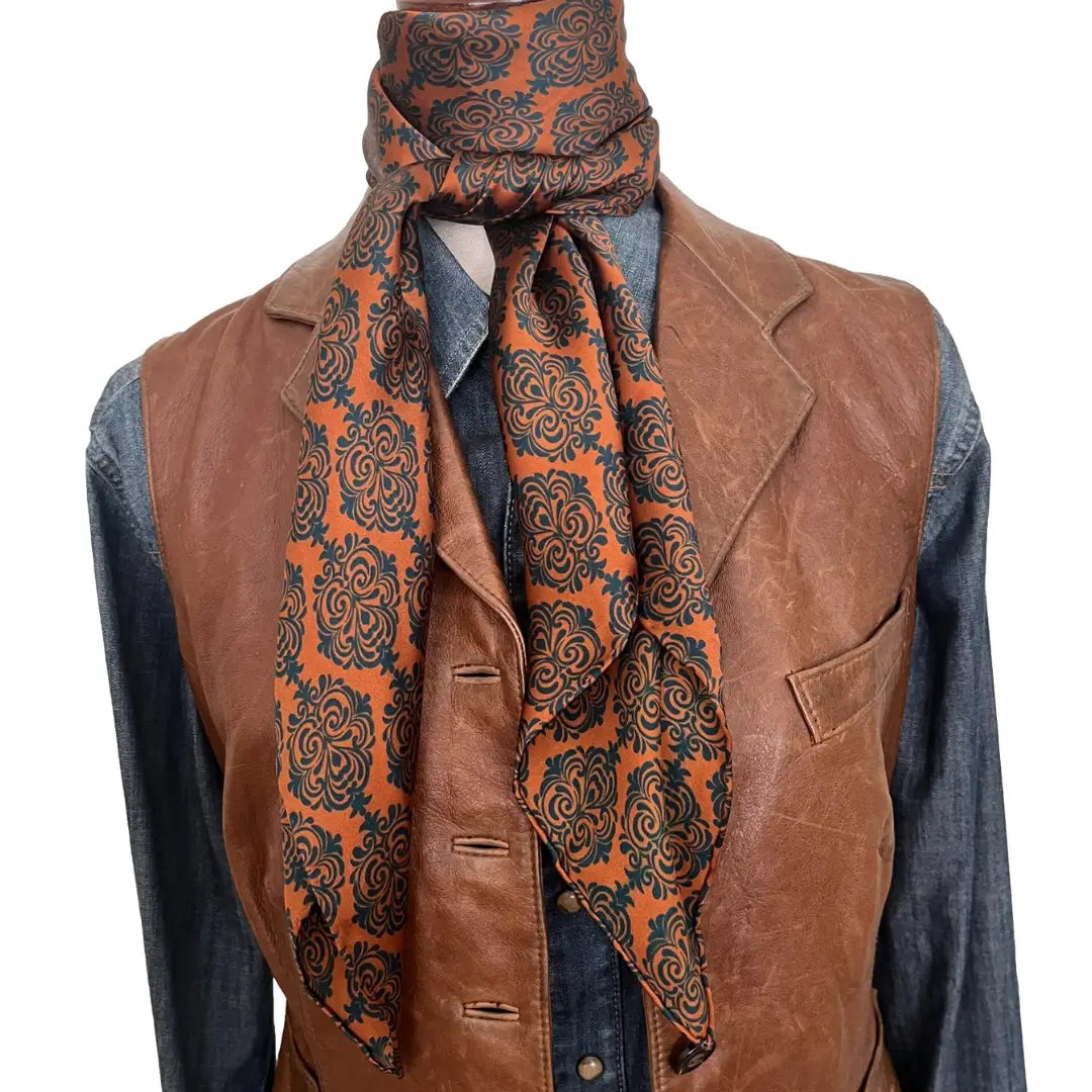 Old western print with teal blue design on a sienna silk scarf. 