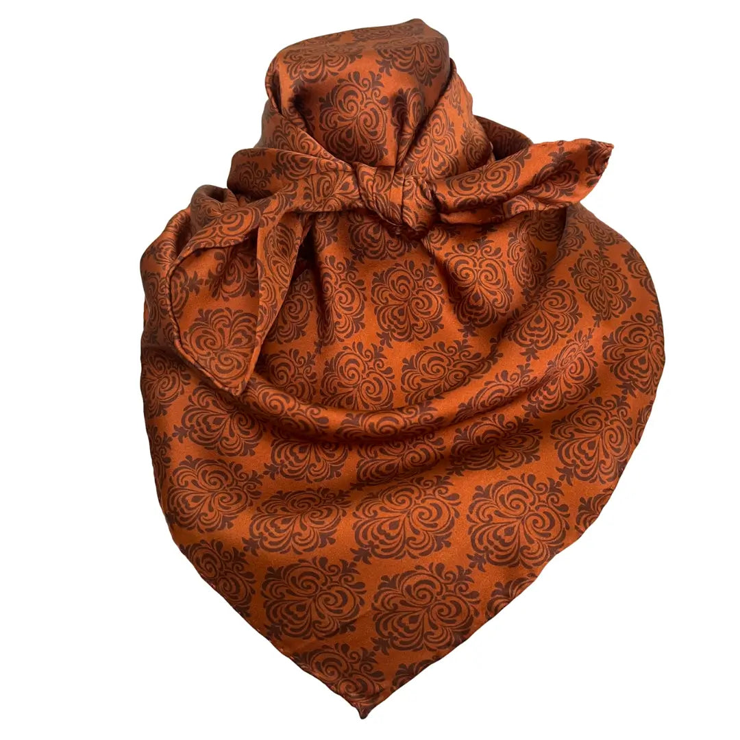 Old western print with dark brown design on a sienna silk scarf. 