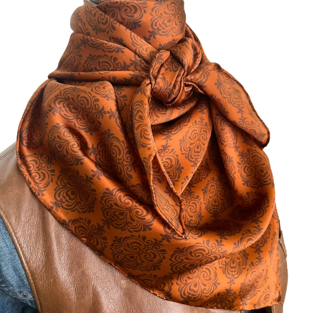 Old western print with dark brown design on a sienna silk scarf. 