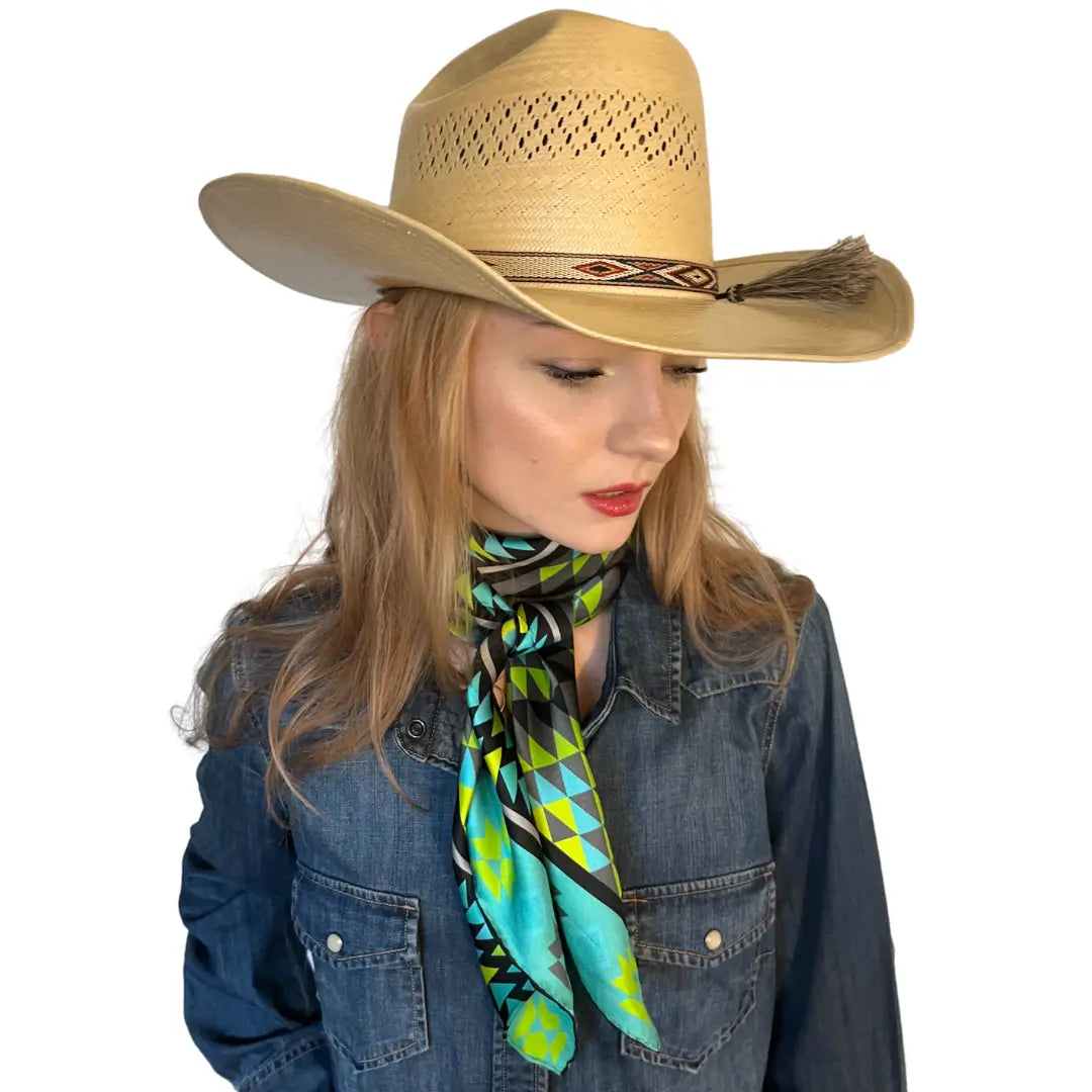 Cowgirl wearing an Aztec wild rag silk scarf with turquoise, neon green, gray, and black.