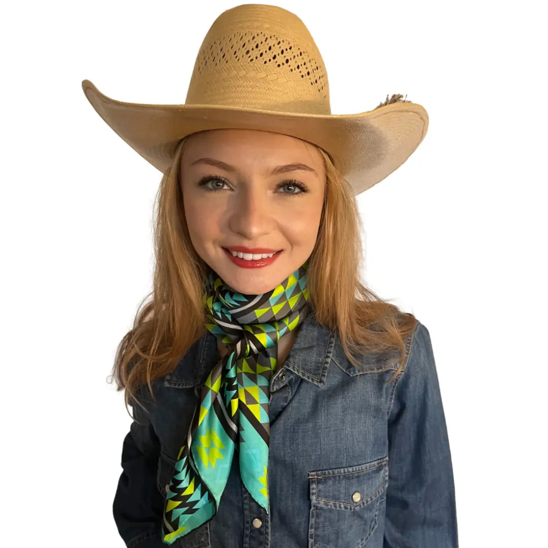 Cowgirl wearing an Aztec wild rag silk scarf with turquoise, neon green, gray, and black.