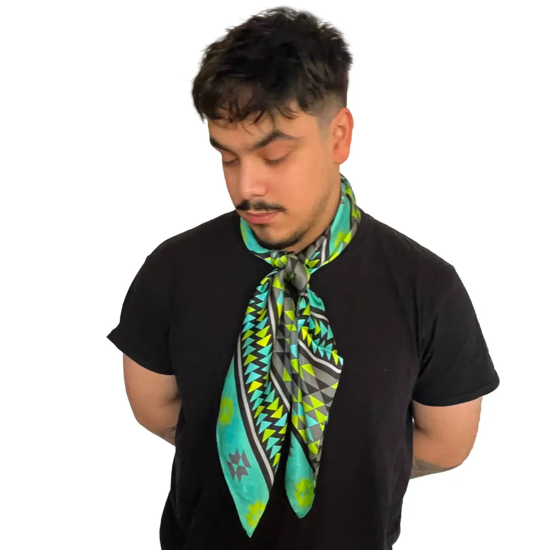 Man wearing an Aztec wild rag silk scarf with turquoise, neon green, gray, and black.