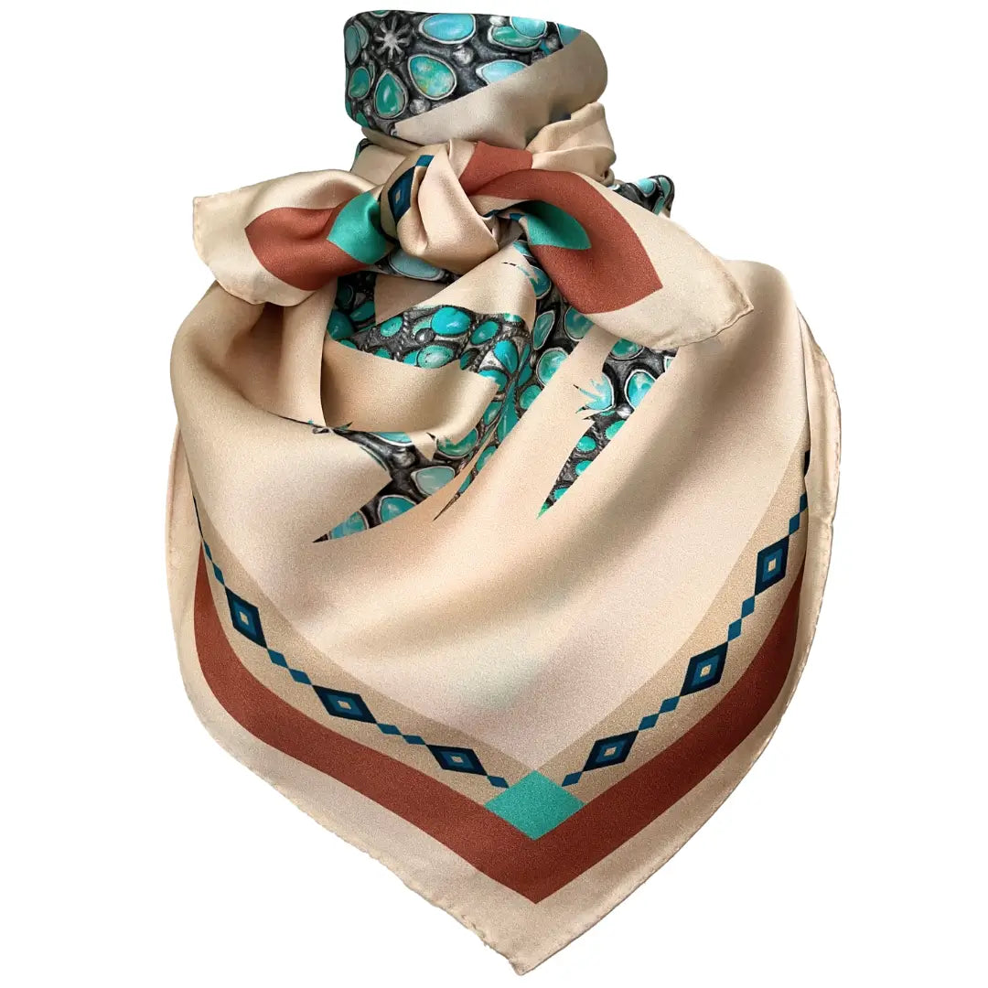 Soft tan wild rag silk scarf with a turquoise design creating a cowgirl and her horse.