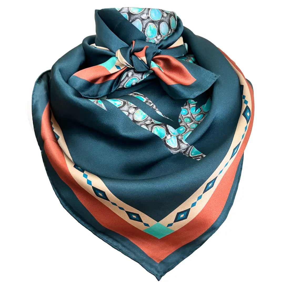 A teal blue and turquoise silk scarf wild rag. Turquoise creates a cowgirl and horse design.