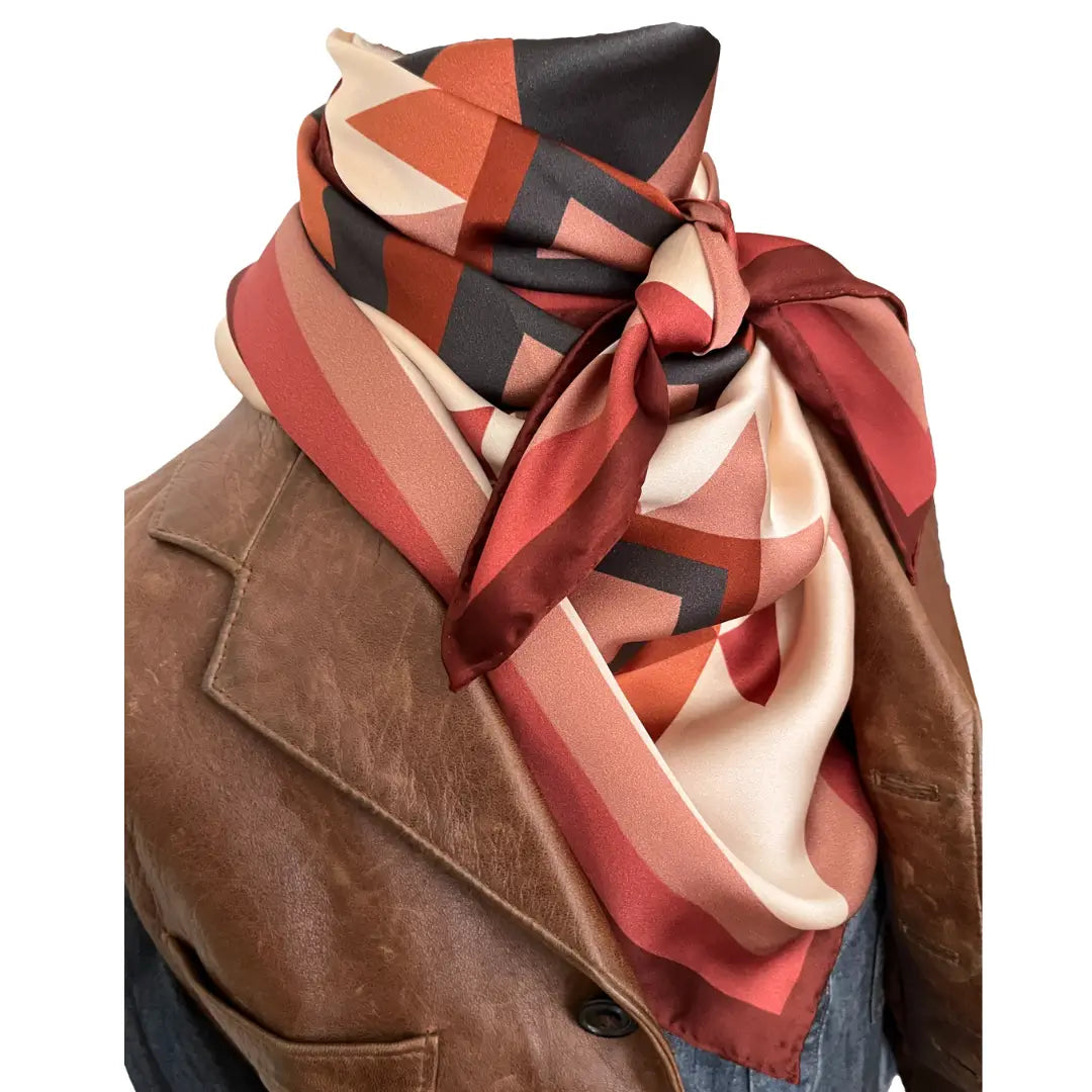 Close-up of Cowtown Wild Rags large Aztec design silk scarf with soft tan, maroon, copper, dusty pink, and charcoal gray.