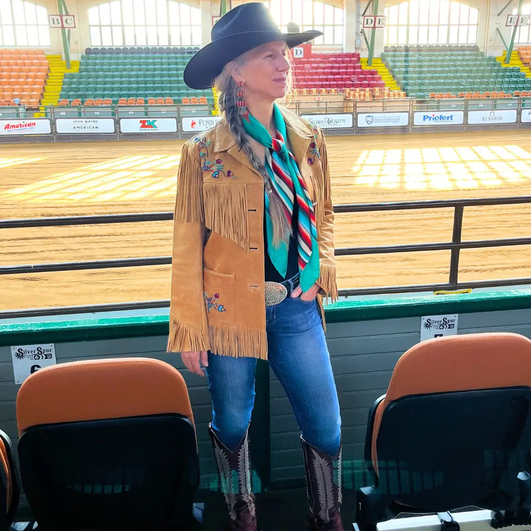 Cowgirl wearing a Cowtown Wild Rags turquoise serape silk scarf with tan, maroon, and coral.