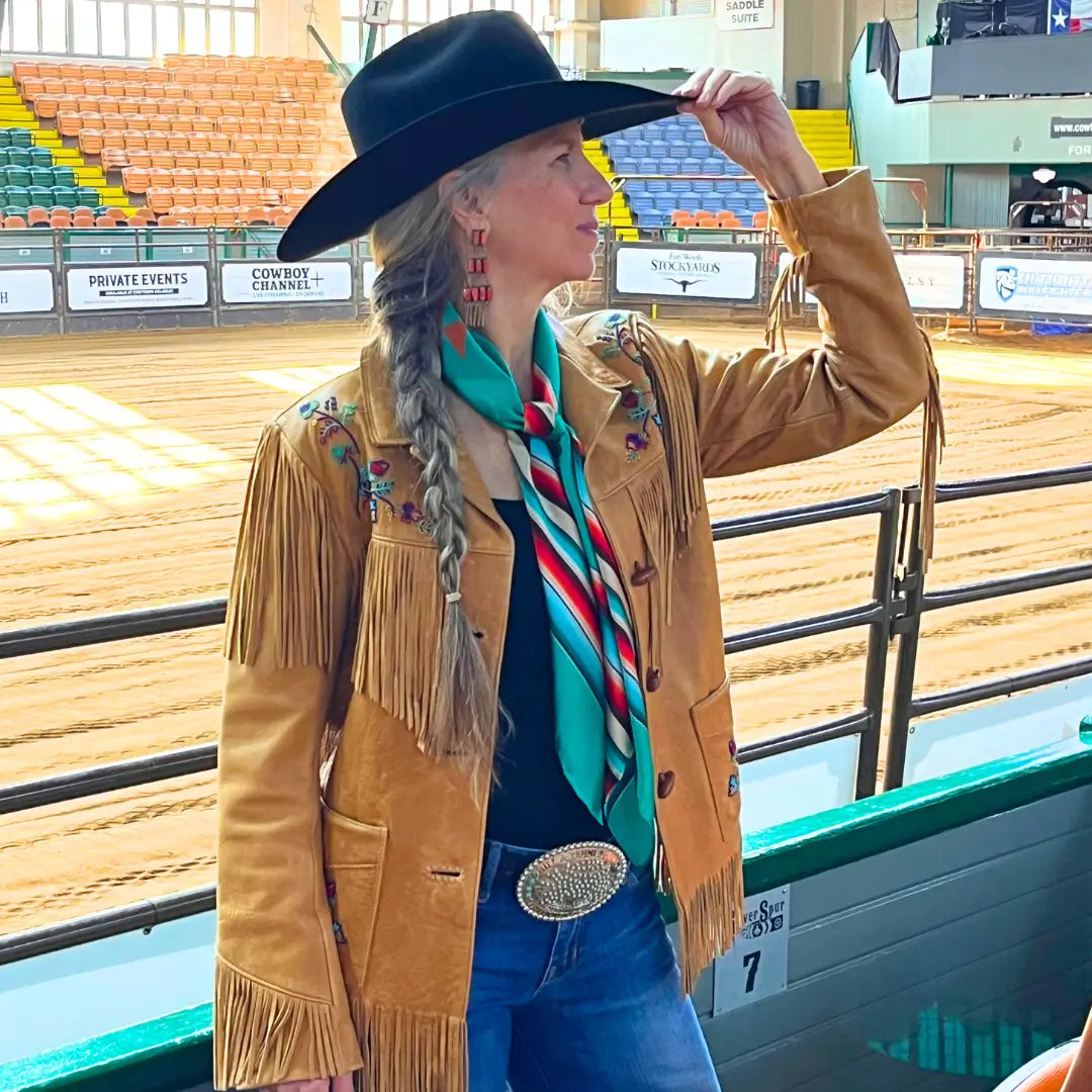 Cowgirl wearing a Cowtown Wild Rags turquoise serape silk scarf with tan, maroon, and coral.