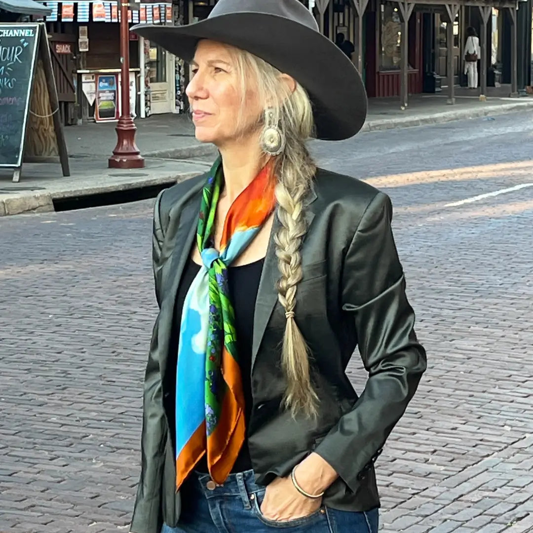 Cowgirl is wearing a longhorn silk scarf wild rag in the Fort Worth Stockyards.