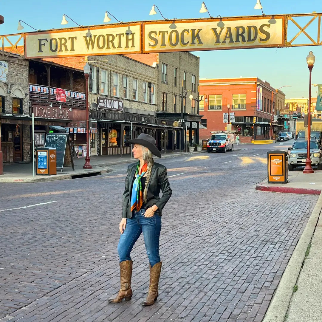 Cowgirl wearing a longhorn silk scarf wild rag in the Fort Worth Stockyards.