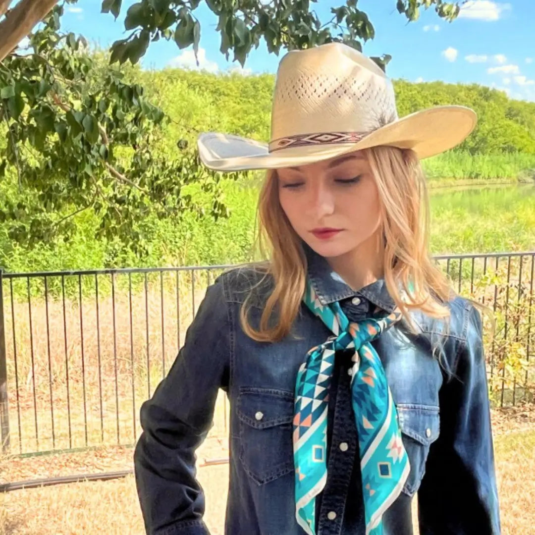 Cowgirl wearing an Aztec wild rag turquoise silk scarf.