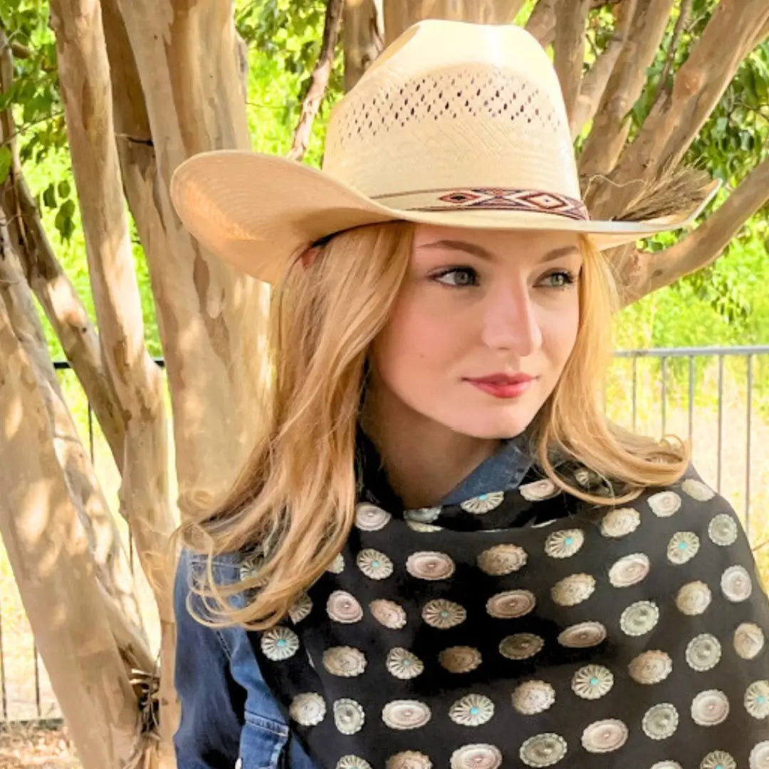 Cowgirl wearing a black wild rag silk scarf with silver conchos.