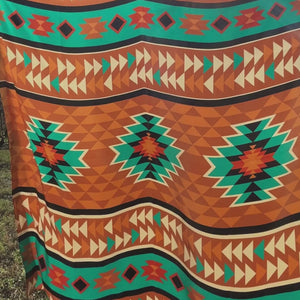 Large Aztec print design with turquoise, copper, burnt orange, cream and black.