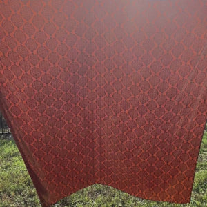 Video of old western print with dark brown design on a sienna silk scarf. 