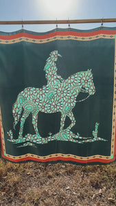 Video of a teal blue and turquoise silk scarf wild rag. Cowgirl and horse design in turquoise.